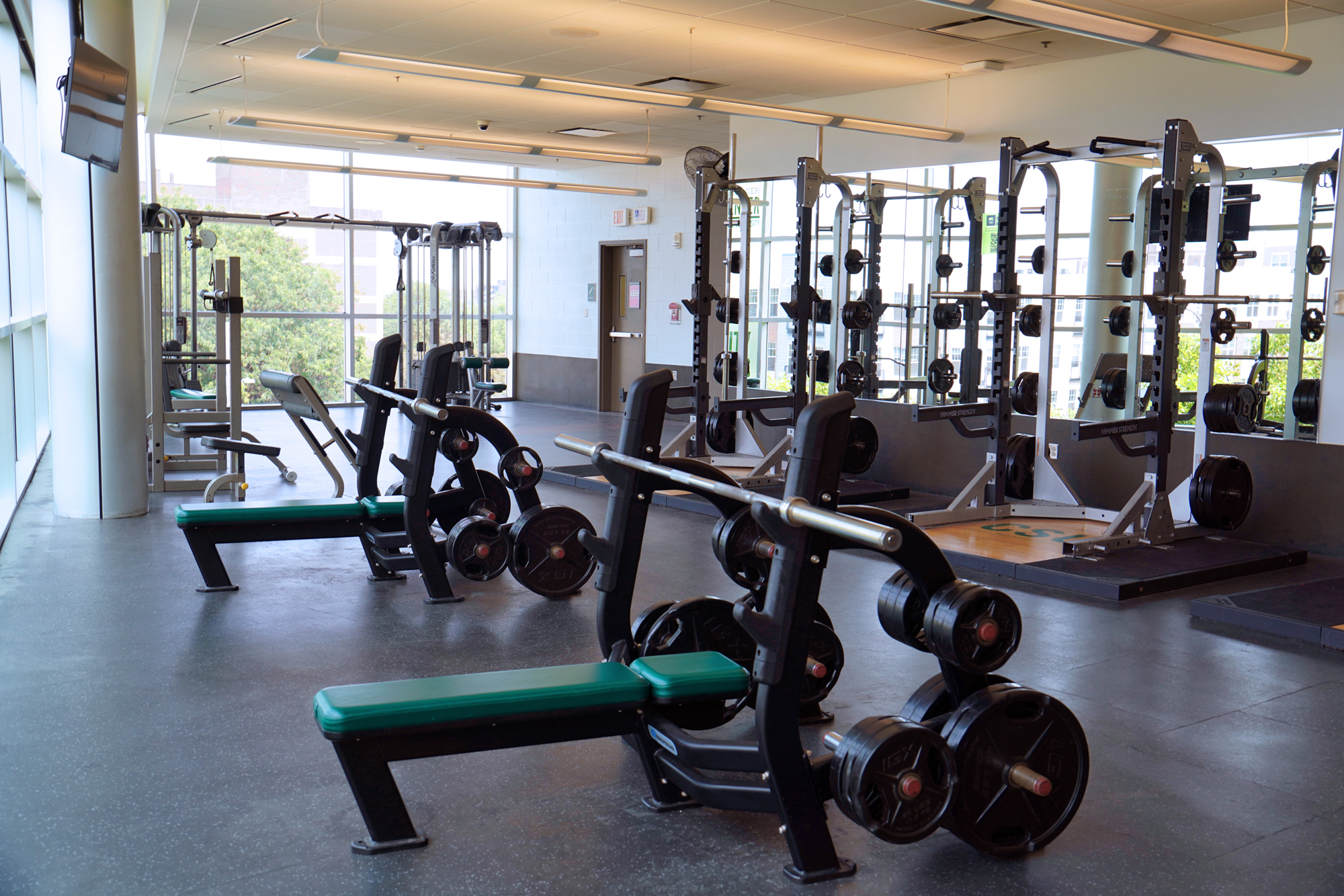 weight room with benches and squat racks